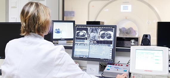 A technician operates a MRI device.