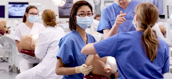 Dental medicine students practice on a dummy